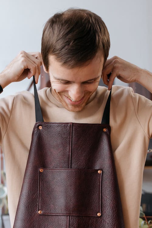 Free Man in Brown Shirt Wearing a Leather Apron Stock Photo