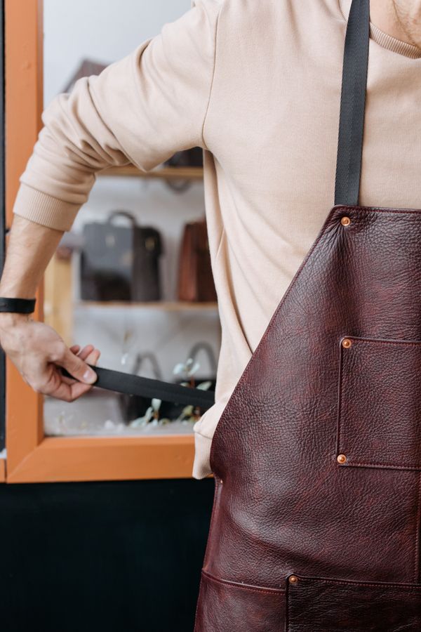 Craftsman in leather workshop apron