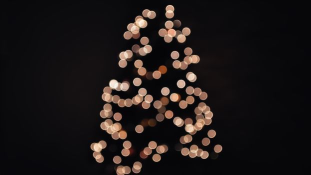 Abstract image of Christmas tree shaped bokeh lights glowing against a dark background., free online jigsaw puzzle on JigsawPuzzlesFreeOnline.org