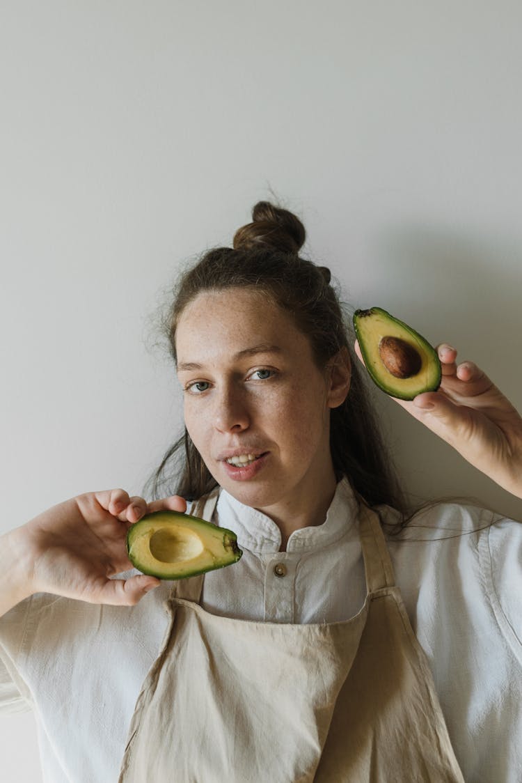 Person Holding Sliced Avocados