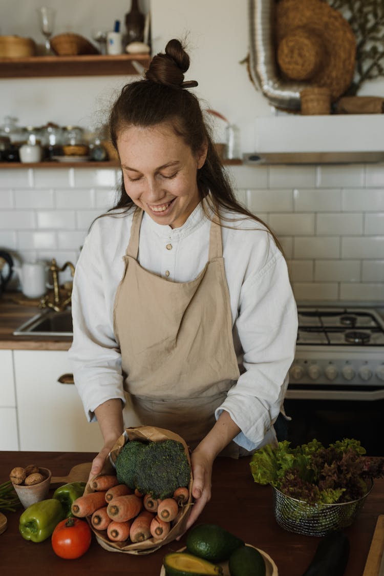 Happy Woman Holding Vegetables