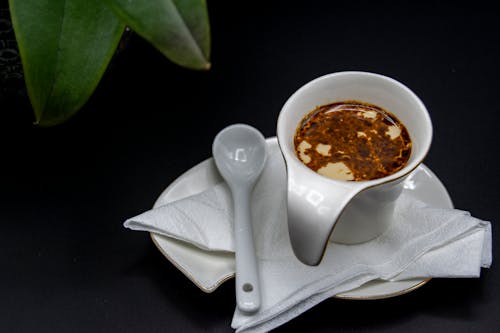 Causer with napkin under oil sauce in gravy boat