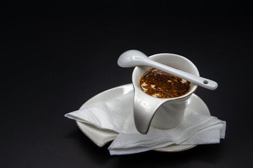Ceramic gravy boat filled with oil sauce