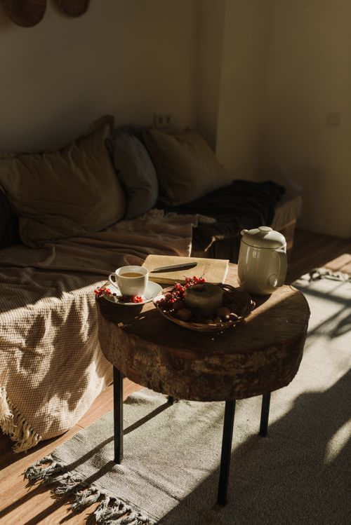 Free Warm, inviting living room setting with a rustic table and teapot, perfect for relaxation. Stock Photo