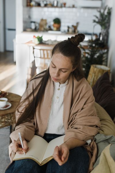 Woman journaling with tea