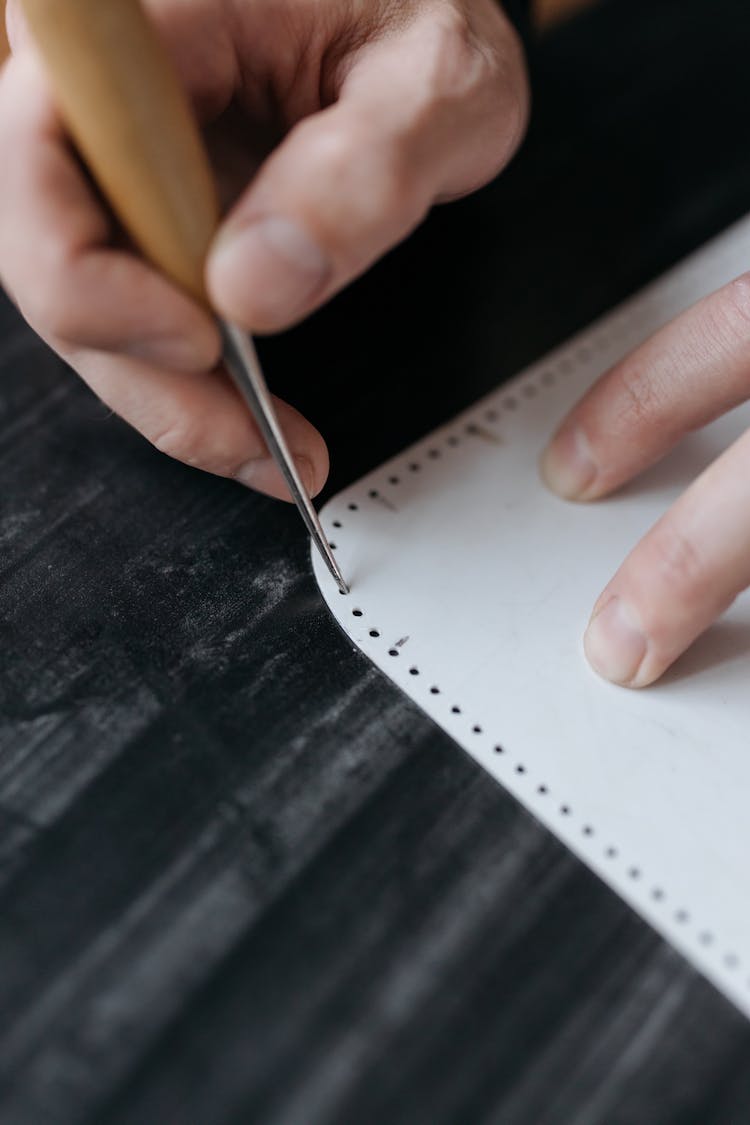 Man Hands Making Holes In Paper