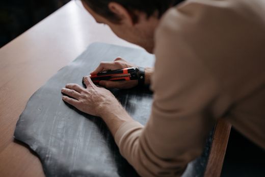 Trimming a panel with a round knife, photo by cottonbro studio on Pexels