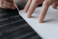 Close-up Photo of a Person Touching a White Material with Holes