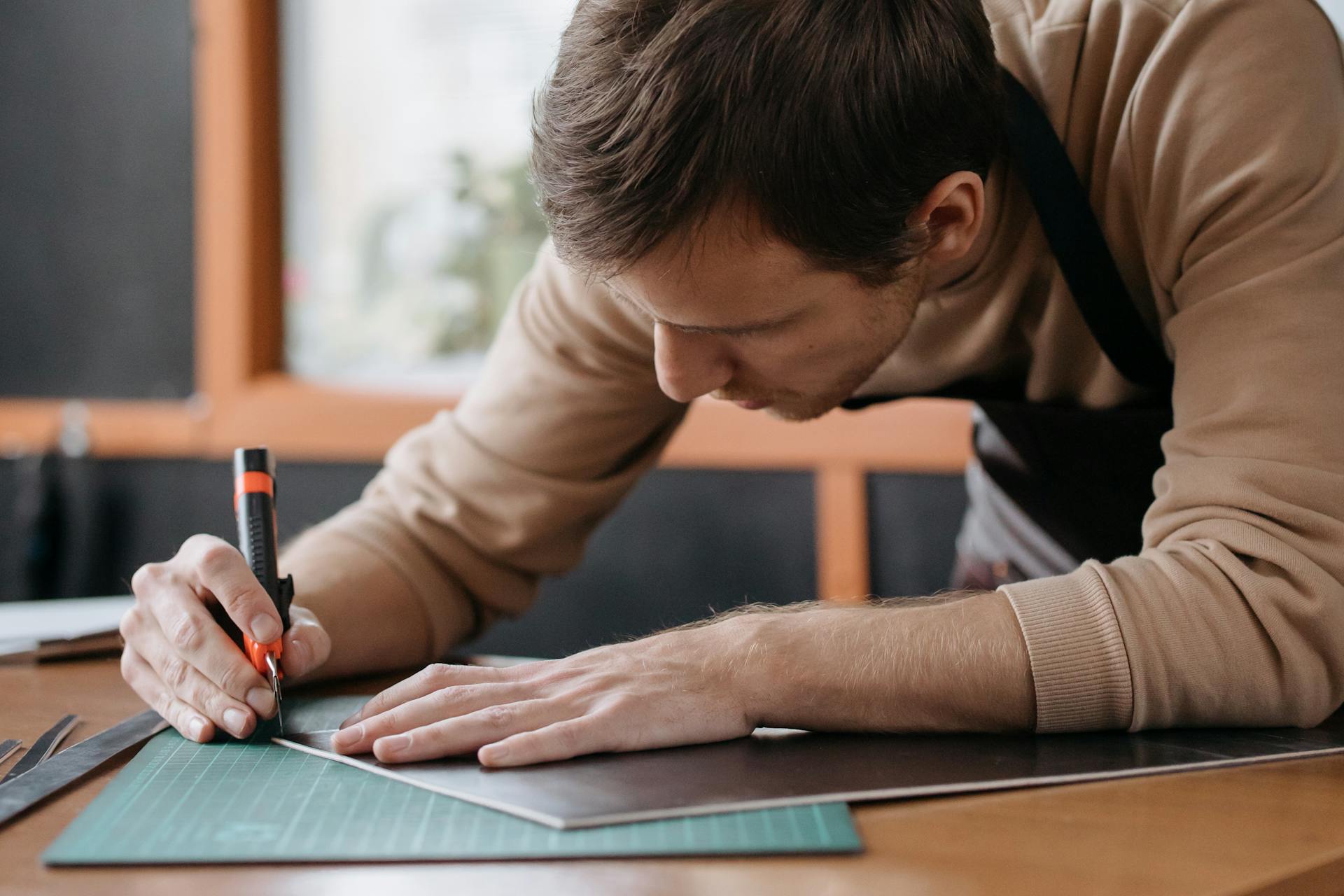 A Man Holding  a Black And Orange Tool