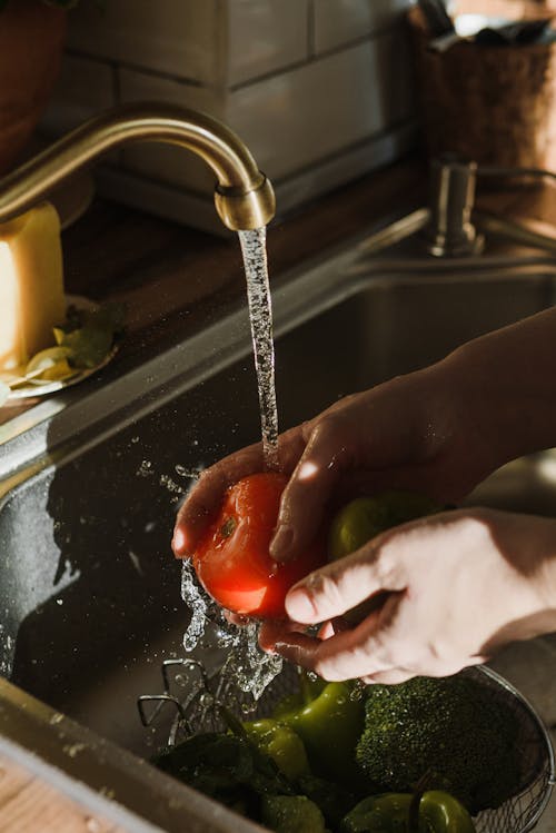 Free Close Up Shot of a Person Washing Tomato on Sink Stock Photo