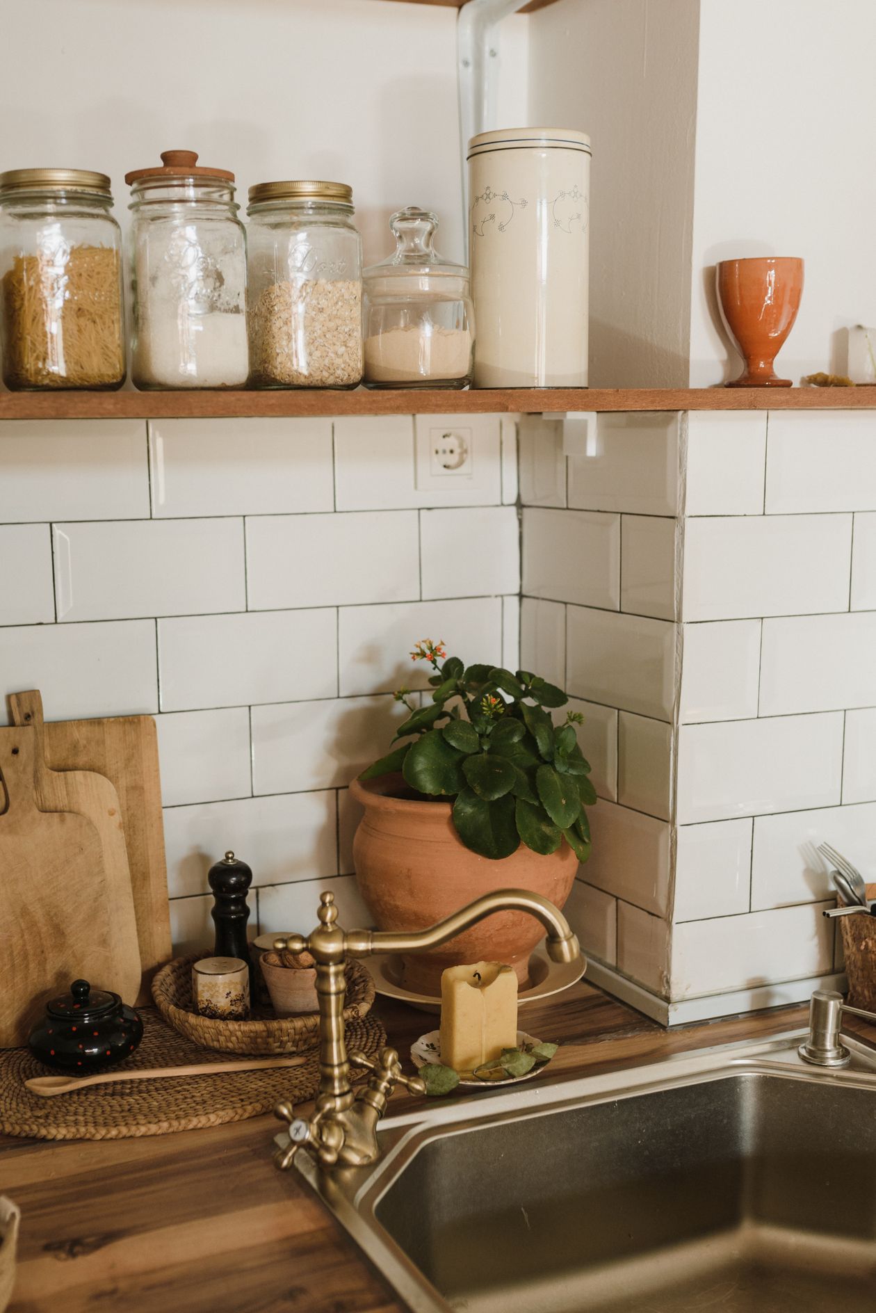 Brass faucet and styled rustic countertop with kitchen accessories