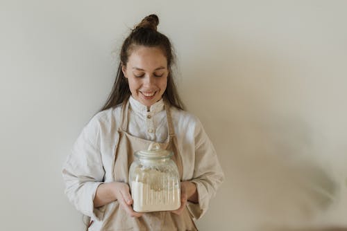 Person Holding a Glass Jar