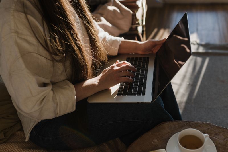 Person typing on a laptop in warm afternoon light — Arina Krasnikova on Pexels
