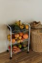 A White 3 tier Rack with Fruits and vegetables