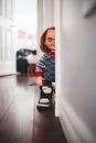 Creative design of doll with knife and horrible face in stylish footwear on floor in house