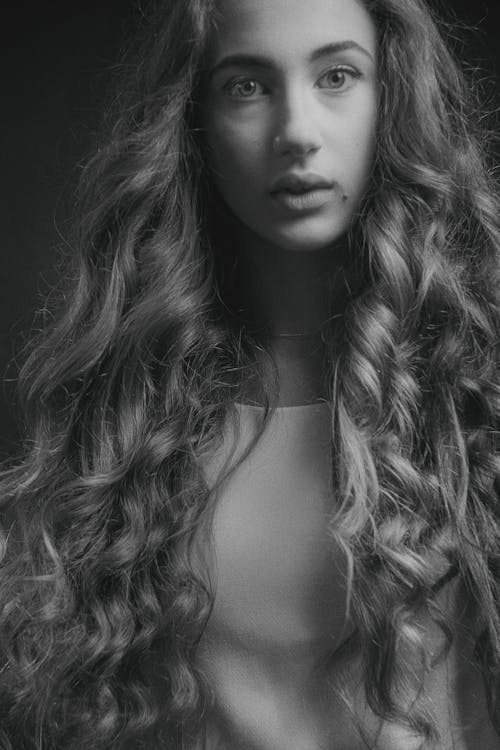 Grayscale Photo of Woman with Curly Hair