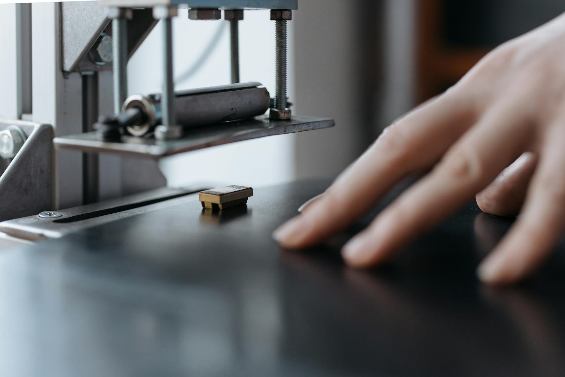 A Person Guiding a Wooden Board into a Machine