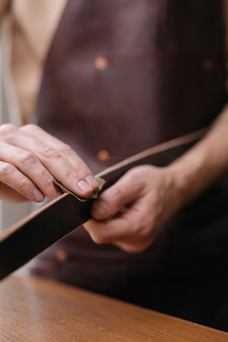 A Person Polishing A Wooden Slab