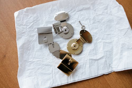 Free Silver and Brass Locks on a White Table Napkin Stock Photo