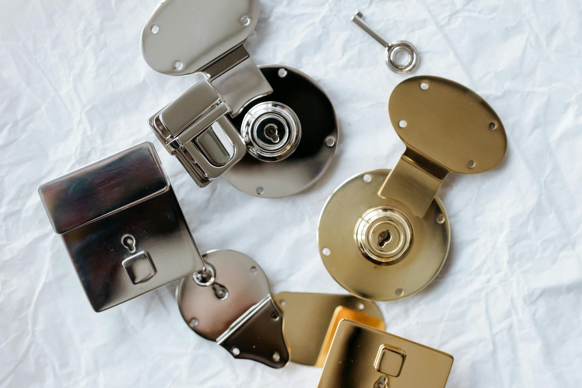 Silver and Gold Locks with Key on a White Table Napkin