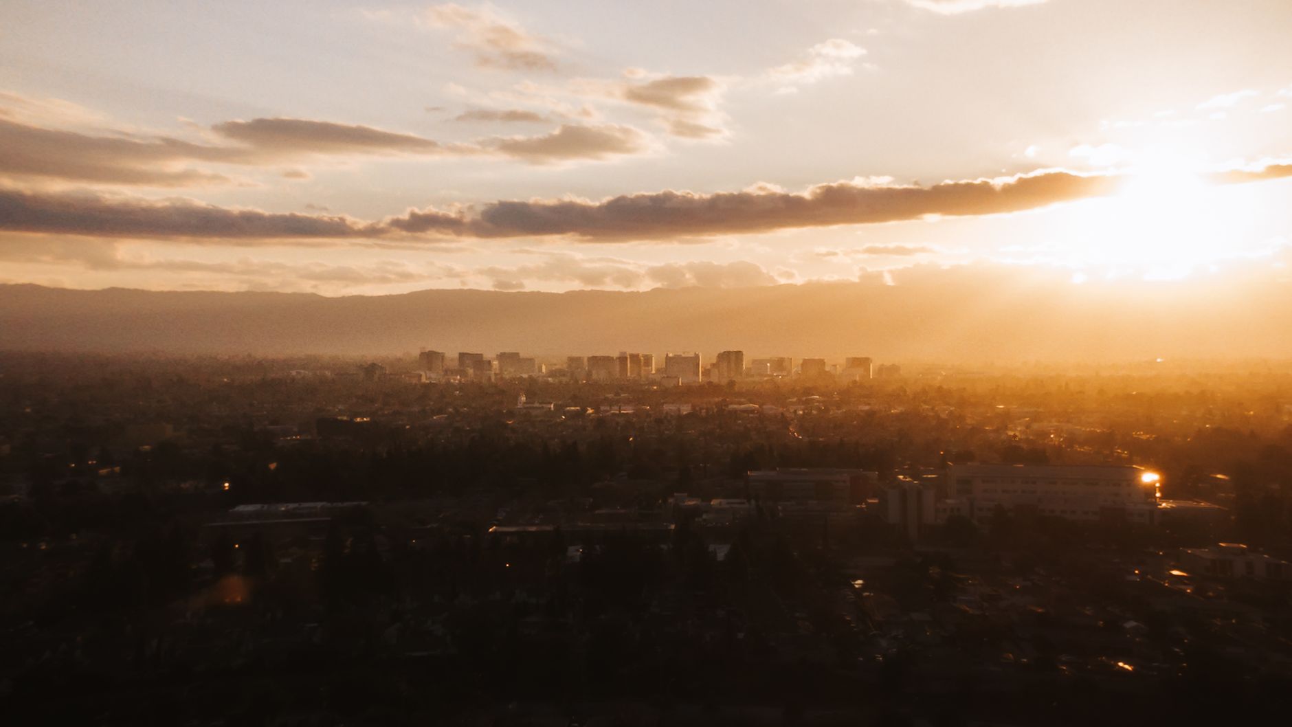 Beautiful aerial view of San Jose skyline during a stunning golden sunset.