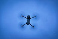 A Drone Flying Under a Clear Blue Sky