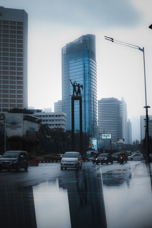 Free A rainy day in Jakarta shows bustling traffic and high-rise buildings. Stock Photo