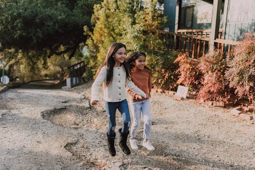 Free Two Girls Standing On Road Feeling Excited Stock Photo