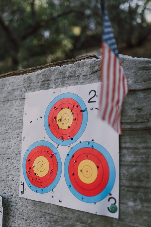 Free Photo of Target Shooting Papers With Holes Stock Photo