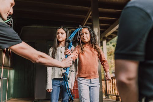 Two Girls Holding an Archery Bow