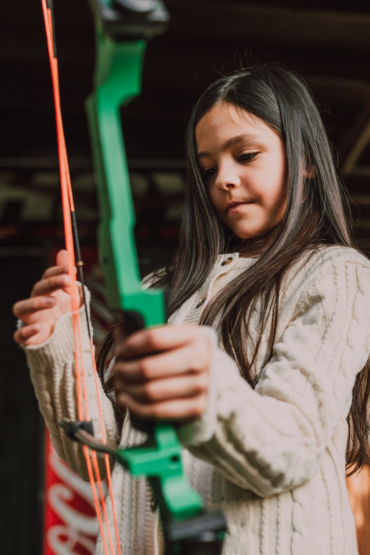 A Girl Holding An Archery Bow