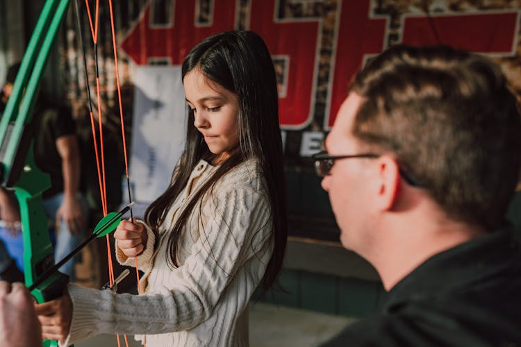 A Girl Holding An Archery Bow