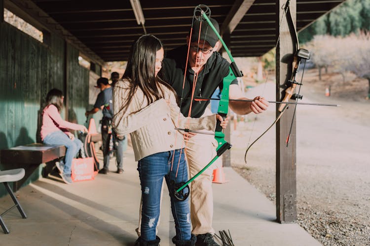 A Girl Holding An Archery Bow