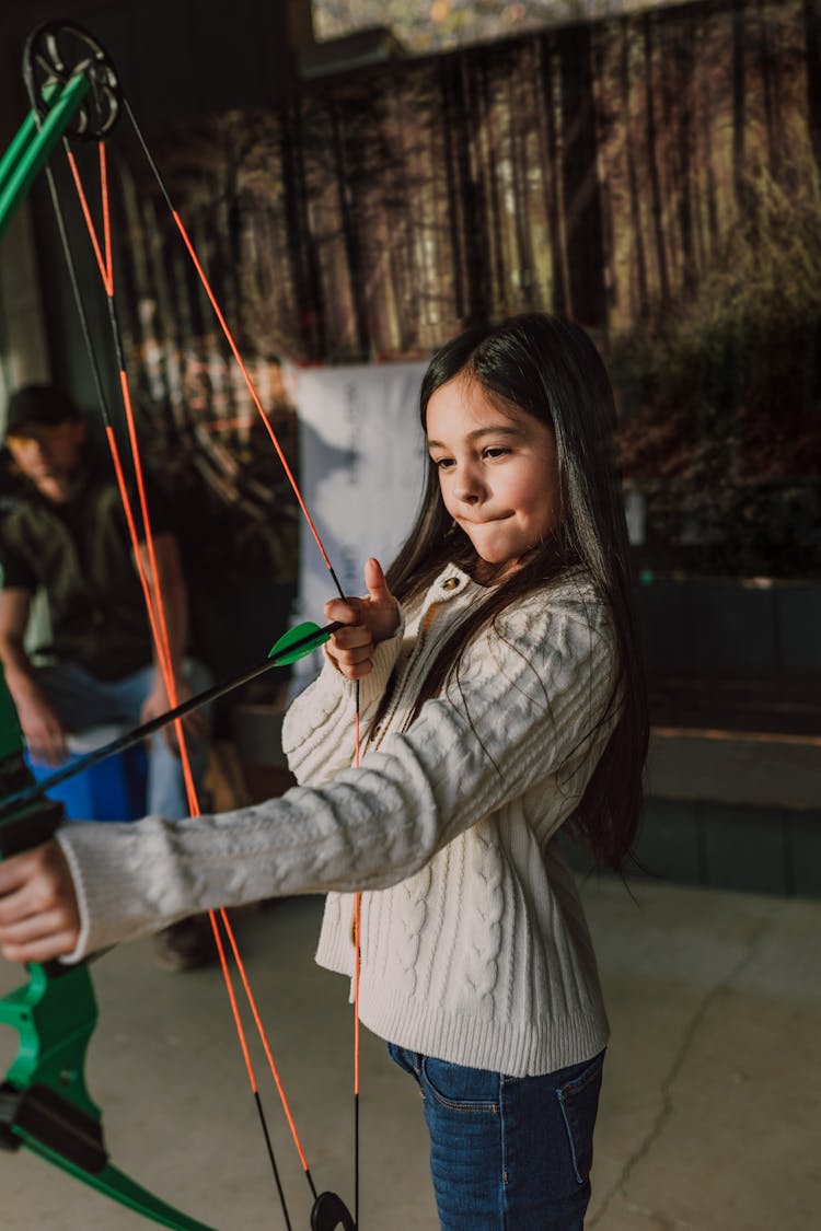 A Girl Holding An Archery Bow