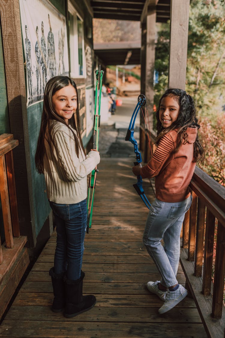 Two Girls Holding An Archery Bow