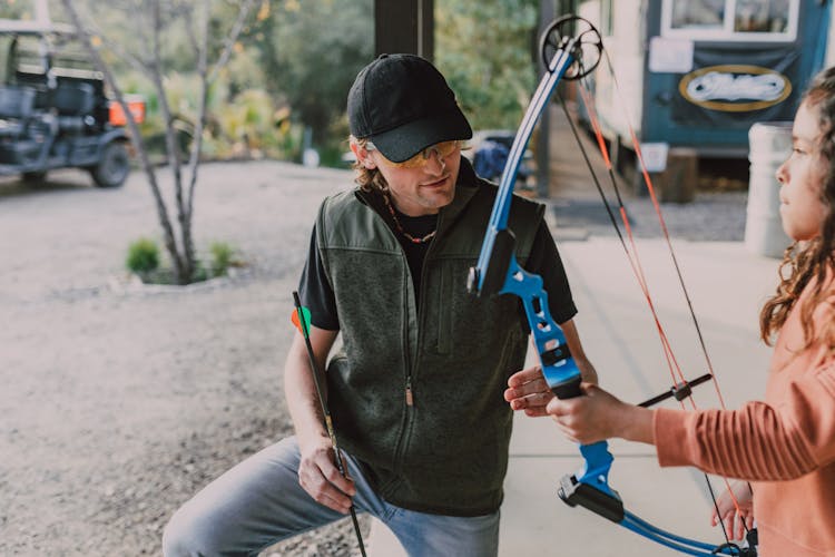 A Girl Holding An Archery Bow