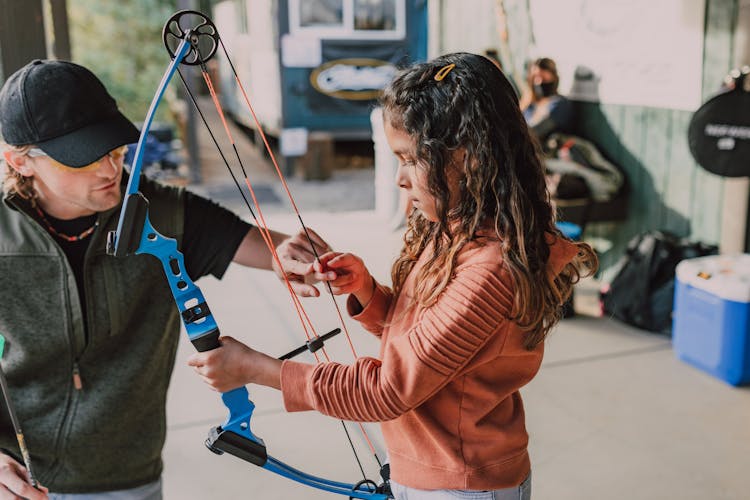 A Girl Holding An Archery Bow