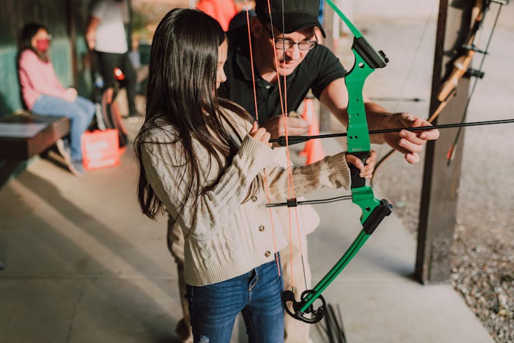 A Girl Holding An Archery Bow