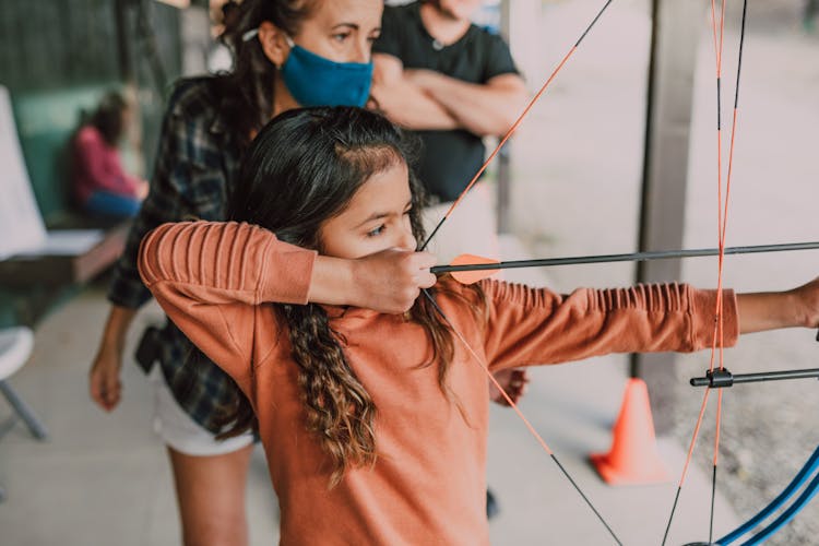 A Girl Holding An Archery Bow