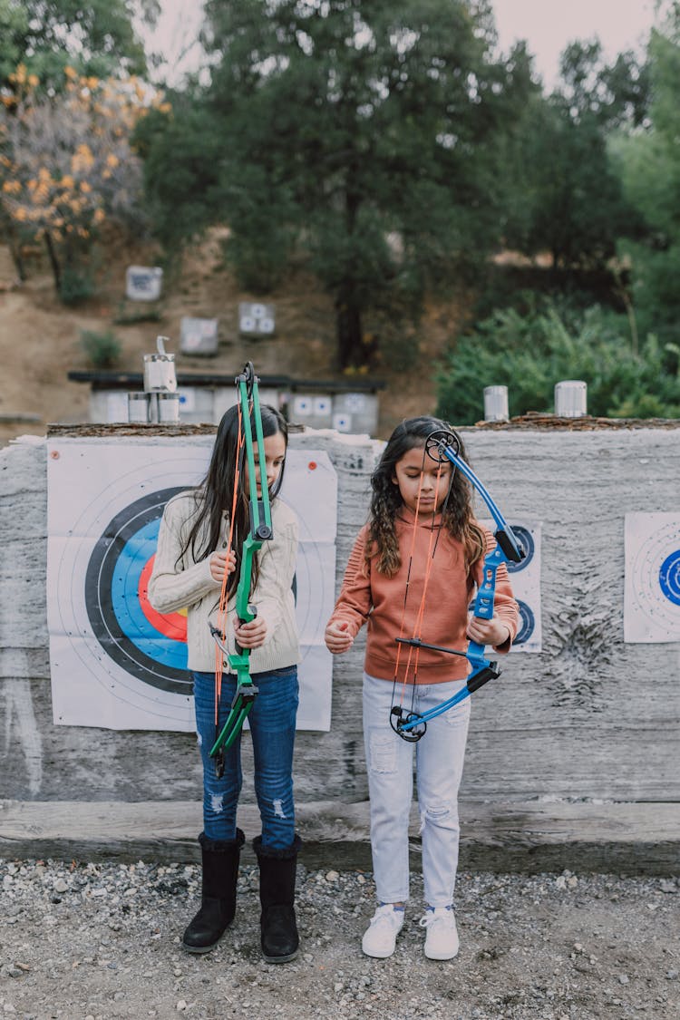 Two Girls Holding An Archery Bow