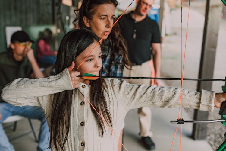 
A Girl Holding An Archery Bow