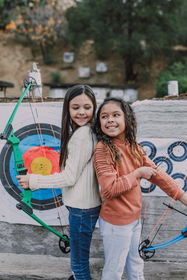 Two Girls Holding An Archery Bow