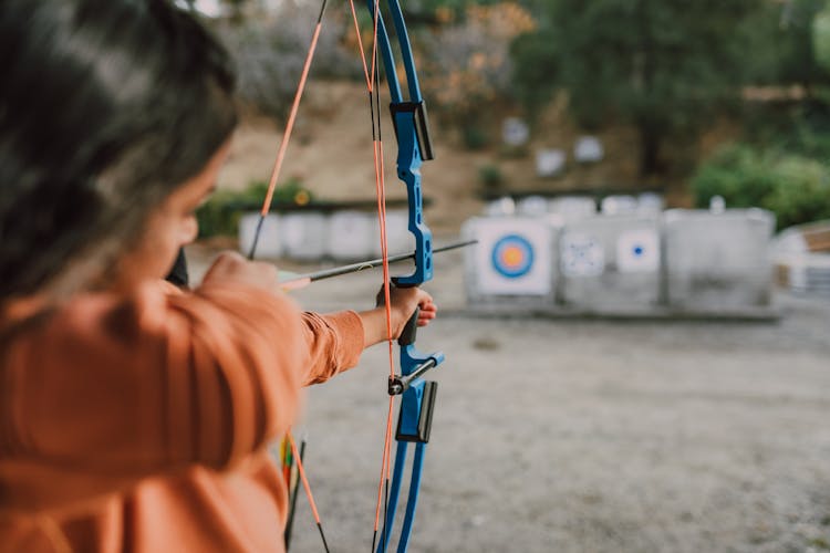 A Person Holding An Archery Bow