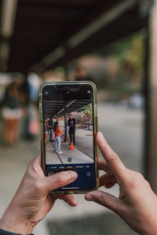 Close-Up Shot of a Person Taking Photo of Archery