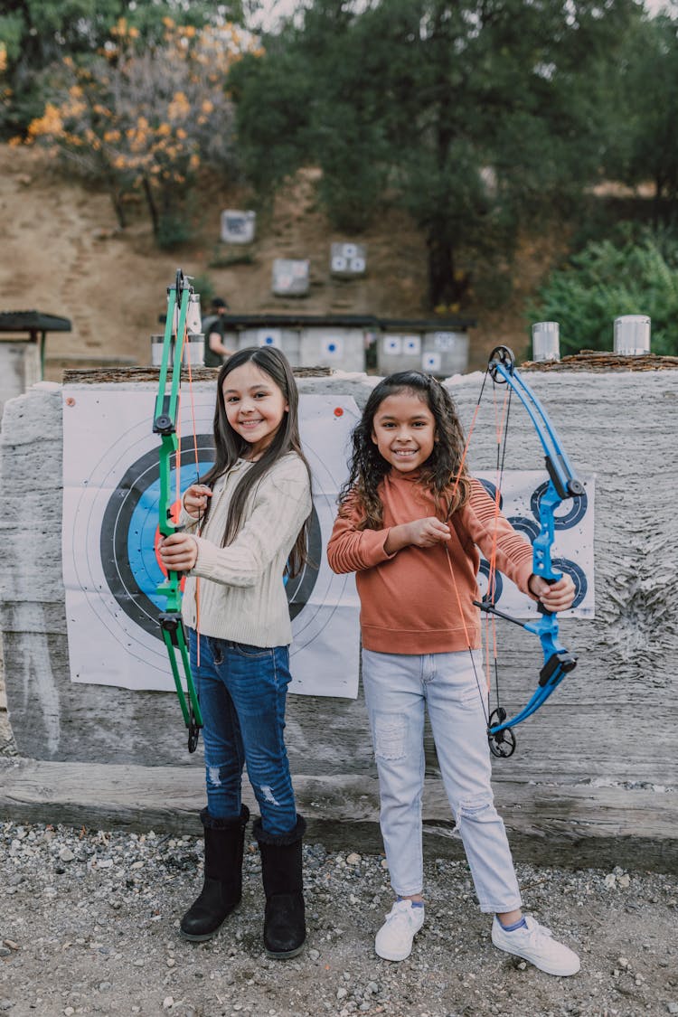 Two Girls Holding An Archery Bow