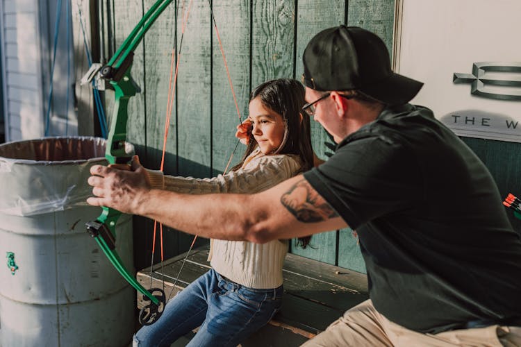 A Girl Holding An Archery Bow