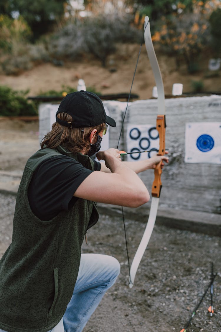 A Person Holding An Archery Bow