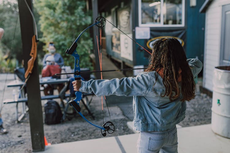 A Girl Holding An Archery Bow