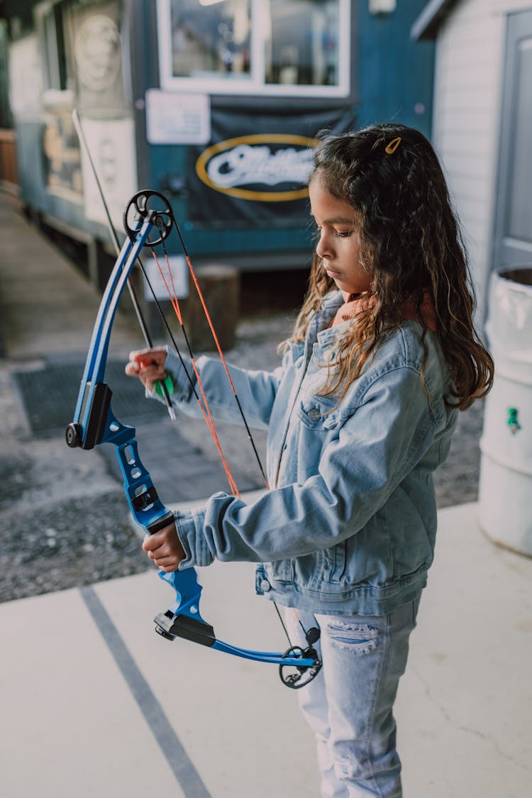 A Girl Holding An Archery Bow