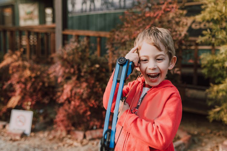 A Boy Holding An Archery Bow